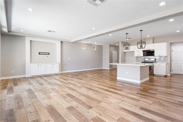 9432 Logan Ridge Ct, Las Vegas, NV 89139 - unfurnished living room featuring recessed lighting and light wood-style flooring