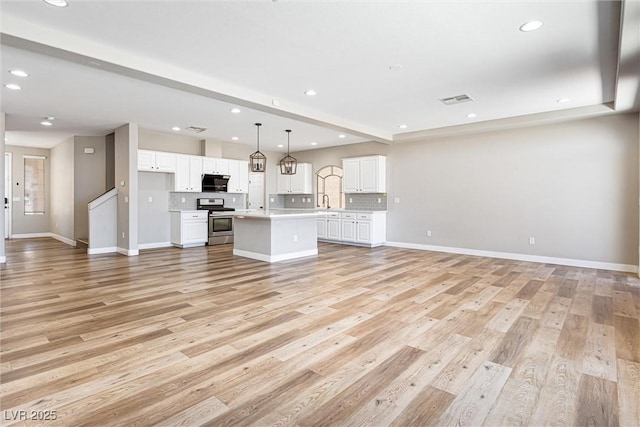 9432 Logan Ridge Ct, Las Vegas, NV 89139 - unfurnished living room featuring light wood-type flooring and recessed lighting