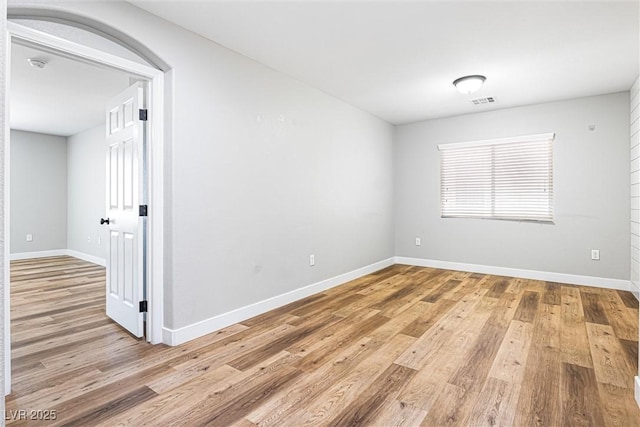 9432 Logan Ridge Ct, Las Vegas, NV 89139 - spare room featuring light wood finished floors, a smoke detector, and arched walkways