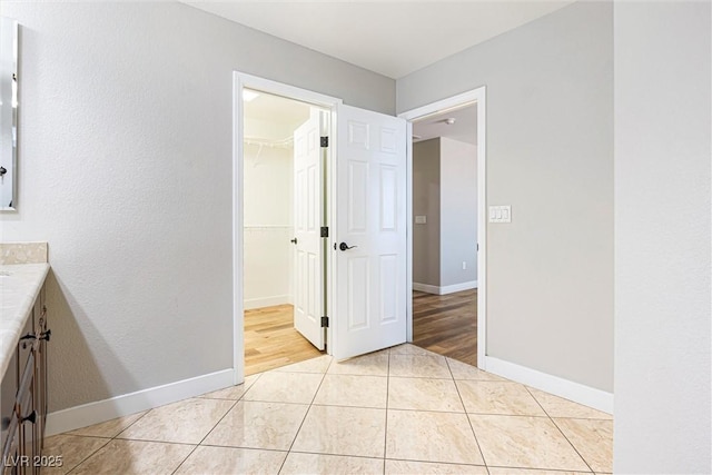9432 Logan Ridge Ct, Las Vegas, NV 89139 - unfurnished bedroom featuring light tile patterned floors, a walk in closet, and a closet