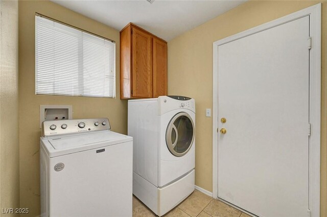 1424 Colt Dr, Henderson, NV 89002 - laundry room featuring washer and clothes dryer, cabinet space, and light tile patterned floors