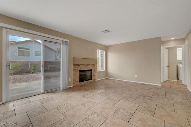 1424 Colt Dr, Henderson, NV 89002 - unfurnished living room with healthy amount of natural light, a glass covered fireplace, and recessed lighting