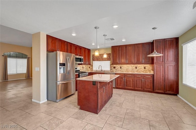 1424 Colt Dr, Henderson, NV 89002 - kitchen featuring stainless steel appliances, tasteful backsplash, hanging light fixtures, a kitchen island, and recessed lighting