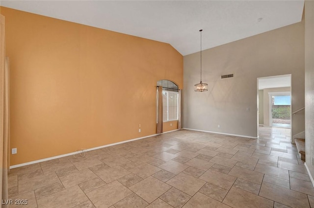 1424 Colt Dr, Henderson, NV 89002 - empty room with high vaulted ceiling, a chandelier, and light stone finish flooring