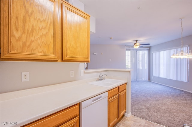 7167 Durango Dr Unit 111, Las Vegas, NV 89148 - kitchen with white dishwasher, a ceiling fan, light colored carpet, light countertops, and decorative light fixtures