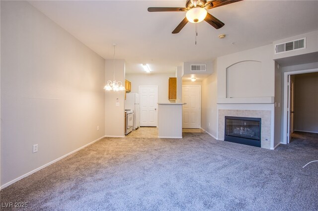 7167 Durango Dr Unit 111, Las Vegas, NV 89148 - unfurnished living room with light carpet, a ceiling fan, a fireplace, and a chandelier