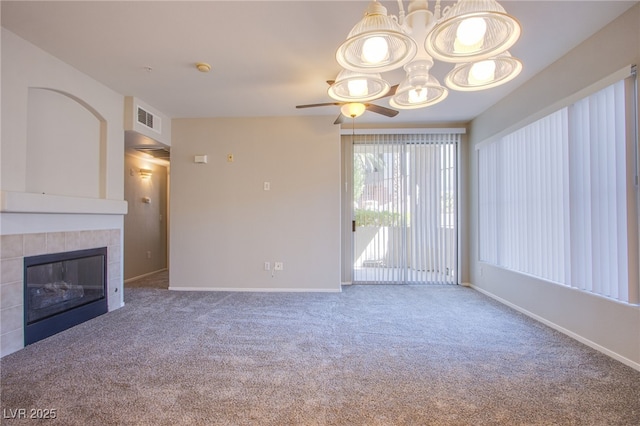 7167 Durango Dr Unit 111, Las Vegas, NV 89148 - unfurnished living room with ceiling fan, carpet, a tiled fireplace, and a chandelier
