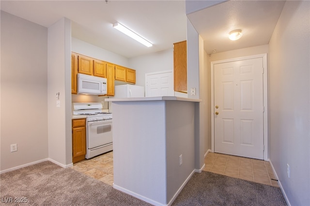 7167 Durango Dr Unit 111, Las Vegas, NV 89148 - kitchen featuring white appliances, light carpet, light countertops, and light tile patterned flooring