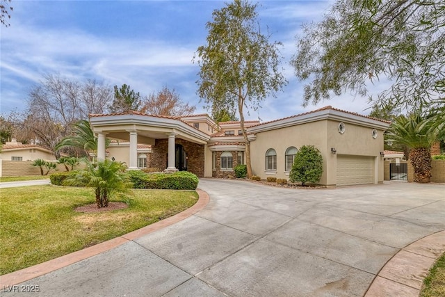 81 Quail Run Rd, Henderson, NV 89014 - mediterranean / spanish-style house featuring a tiled roof, driveway, stucco siding, and a garage