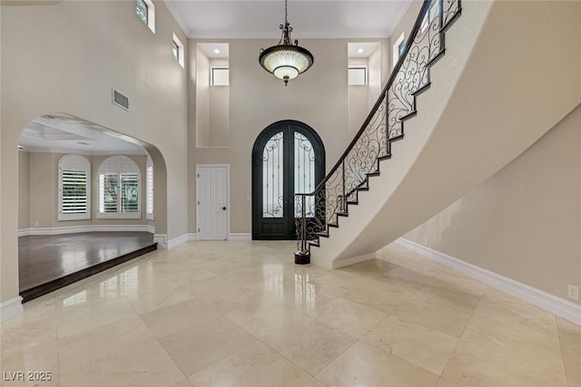 81 Quail Run Rd, Henderson, NV 89014 - entrance foyer featuring arched walkways, a towering ceiling, ornamental molding, and stairway