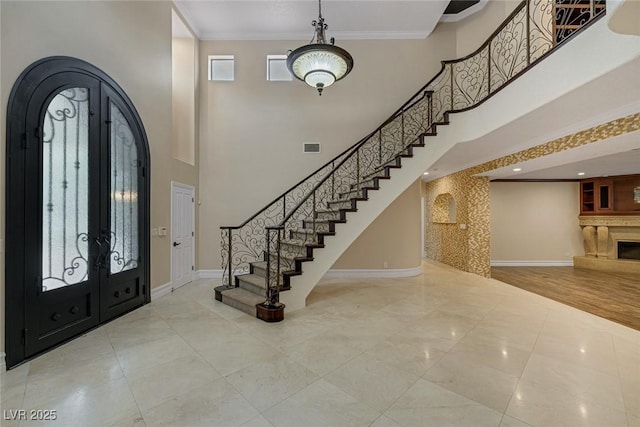 81 Quail Run Rd, Henderson, NV 89014 - foyer with arched walkways, stairway, crown molding, french doors, and a towering ceiling