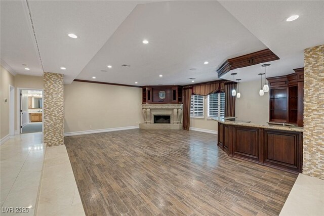 81 Quail Run Rd, Henderson, NV 89014 - unfurnished living room with a fireplace with raised hearth, recessed lighting, ornamental molding, and light wood finished floors