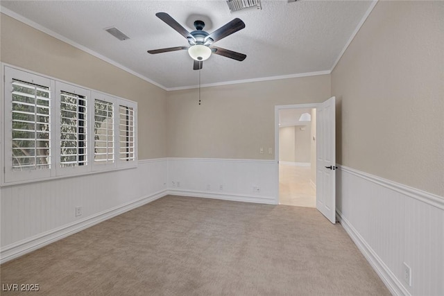 81 Quail Run Rd, Henderson, NV 89014 - spare room featuring ceiling fan, a wainscoted wall, carpet, a textured ceiling, and crown molding