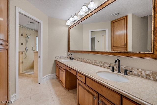 81 Quail Run Rd, Henderson, NV 89014 - bathroom with a stall shower, double vanity, a textured ceiling, and tile patterned flooring