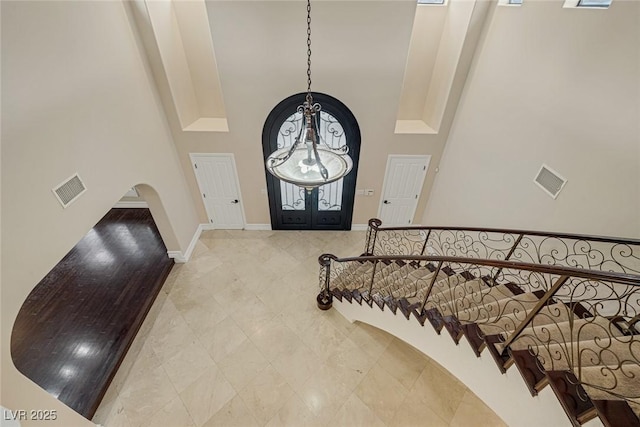 81 Quail Run Rd, Henderson, NV 89014 - entrance foyer with a high ceiling, a chandelier, arched walkways, and stairs