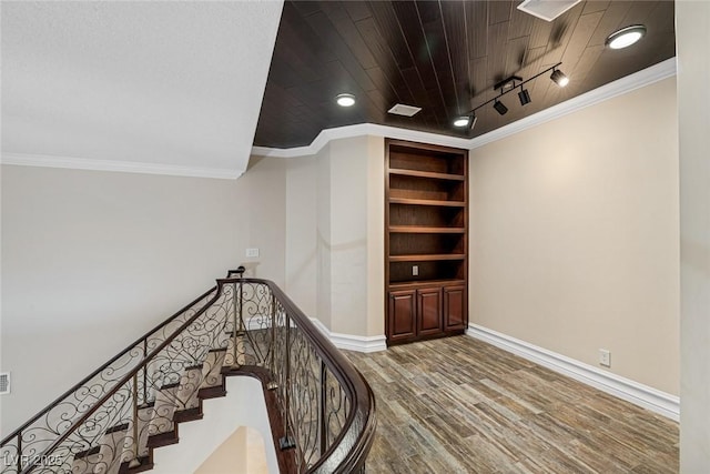 81 Quail Run Rd, Henderson, NV 89014 - stairs with wood finished floors, track lighting, wooden ceiling, crown molding, and recessed lighting