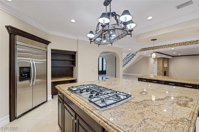 81 Quail Run Rd, Henderson, NV 89014 - kitchen with appliances with stainless steel finishes, arched walkways, a chandelier, hanging light fixtures, and crown molding
