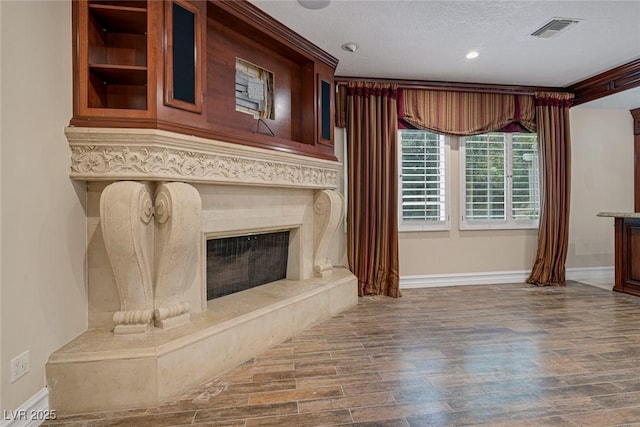 81 Quail Run Rd, Henderson, NV 89014 - unfurnished living room with wood finished floors, a textured ceiling, a fireplace, and recessed lighting