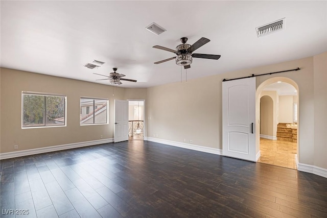 81 Quail Run Rd, Henderson, NV 89014 - unfurnished room with arched walkways, ceiling fan, and dark wood-style floors