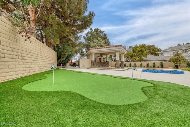 81 Quail Run Rd, Henderson, NV 89014 - view of property's community with an area to practice putting, a fenced backyard, a swimming pool, and a patio