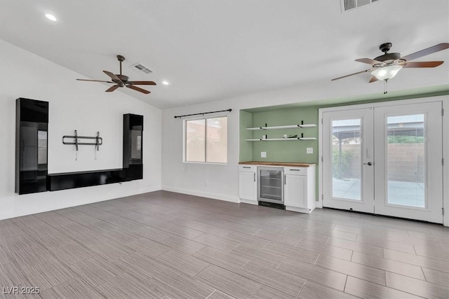 658 Turtleback Dr, North Las Vegas, NV 89031 - unfurnished living room featuring wine cooler, ceiling fan, healthy amount of natural light, vaulted ceiling, and recessed lighting