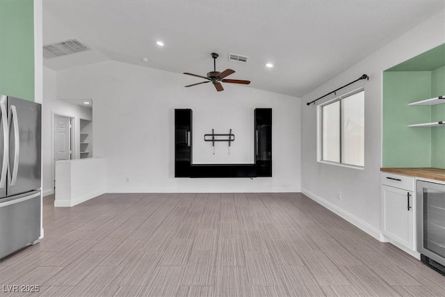 658 Turtleback Dr, North Las Vegas, NV 89031 - interior space with wine cooler, lofted ceiling, a ceiling fan, recessed lighting, and light wood finished floors