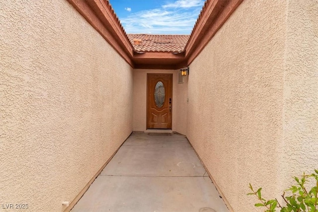 658 Turtleback Dr, North Las Vegas, NV 89031 - doorway to property featuring stucco siding and a tile roof
