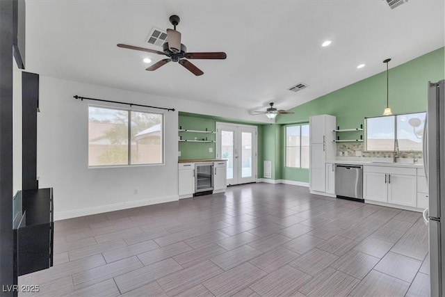 658 Turtleback Dr, North Las Vegas, NV 89031 - unfurnished living room featuring beverage cooler, a ceiling fan, lofted ceiling, and recessed lighting