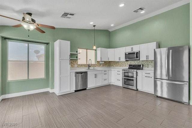 658 Turtleback Dr, North Las Vegas, NV 89031 - kitchen featuring appliances with stainless steel finishes, light countertops, backsplash, ceiling fan, and high vaulted ceiling