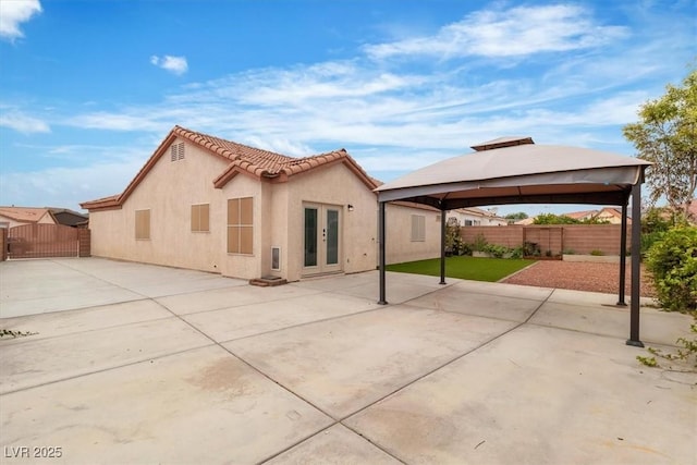 658 Turtleback Dr, North Las Vegas, NV 89031 - back of property with a gazebo, french doors, stucco siding, a patio area, and a tiled roof