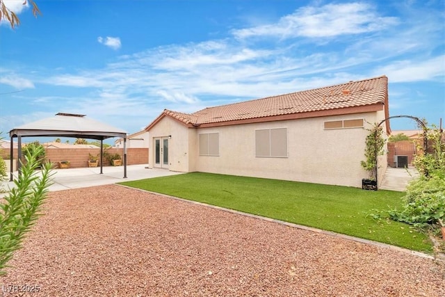 658 Turtleback Dr, North Las Vegas, NV 89031 - rear view of property featuring a gazebo, a patio area, stucco siding, and a tiled roof