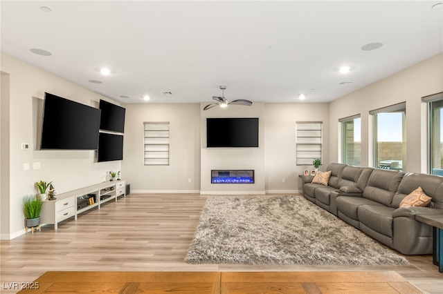 186 Vista Balla Ave, Las Vegas, NV 89138 - living area with a glass covered fireplace, a ceiling fan, light wood-type flooring, and recessed lighting