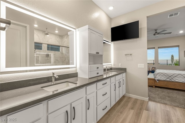 186 Vista Balla Ave, Las Vegas, NV 89138 - full bath with double vanity, ceiling fan, wood finished floors, a marble finish shower, and recessed lighting