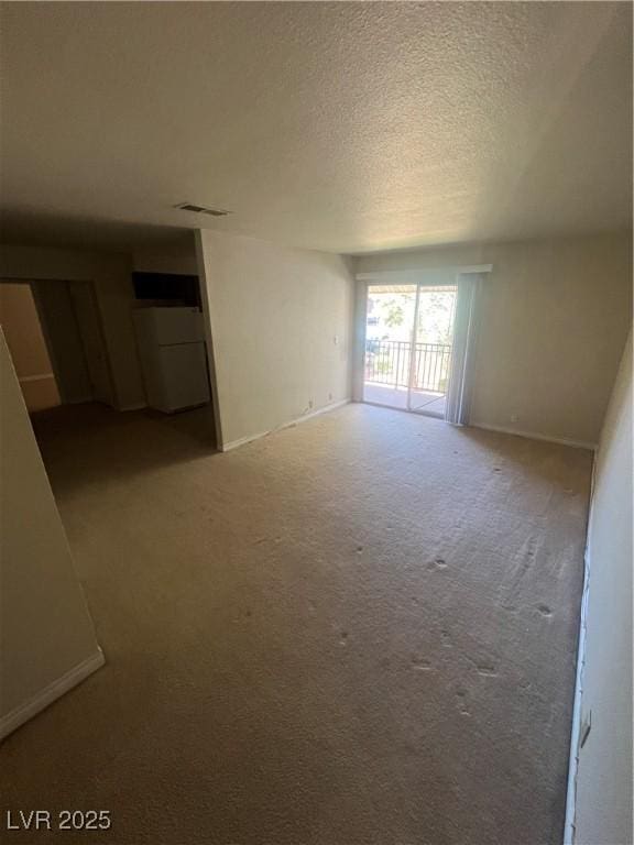 5350 River Glen Dr Unit 298, Las Vegas, NV 89103 - empty room with carpet flooring and a textured ceiling