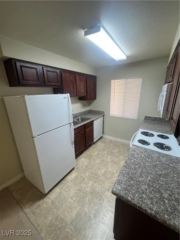 5350 River Glen Dr Unit 298, Las Vegas, NV 89103 - kitchen with white appliances, dark countertops, and a textured ceiling