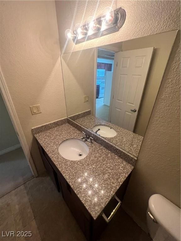 5350 River Glen Dr Unit 298, Las Vegas, NV 89103 - bathroom featuring a textured wall and vanity