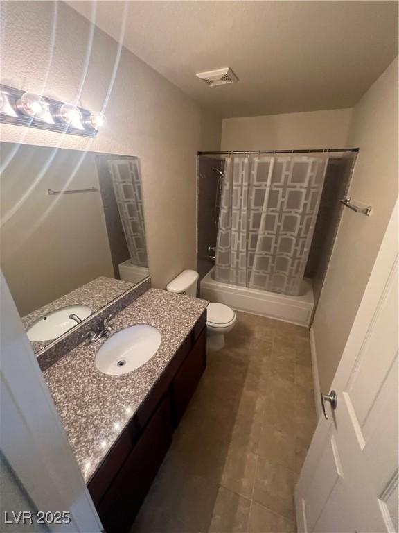 5350 River Glen Dr Unit 298, Las Vegas, NV 89103 - full bathroom with vanity, shower / bathtub combination with curtain, and tile patterned floors