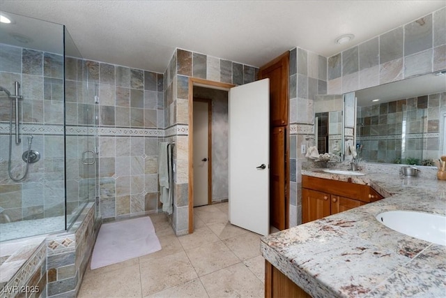 2917 Chapala Dr, Las Vegas, NV 89120 - bathroom featuring vanity, tile walls, a stall shower, and tile patterned floors