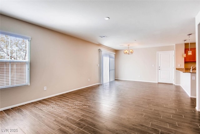 3116 Paladi Ave, Henderson, NV 89044 - unfurnished living room with a chandelier and dark wood finished floors