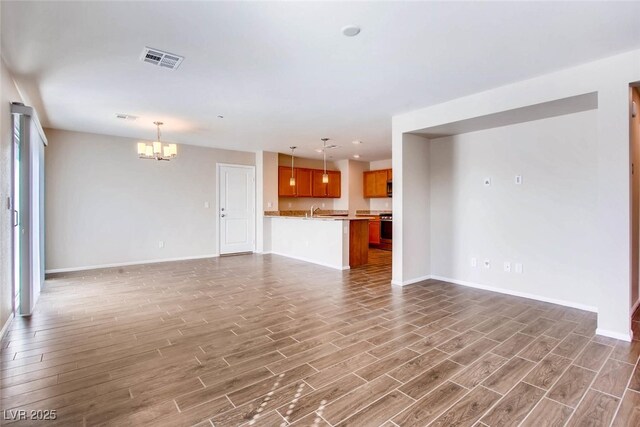 3116 Paladi Ave, Henderson, NV 89044 - unfurnished living room featuring a chandelier and wood finished floors