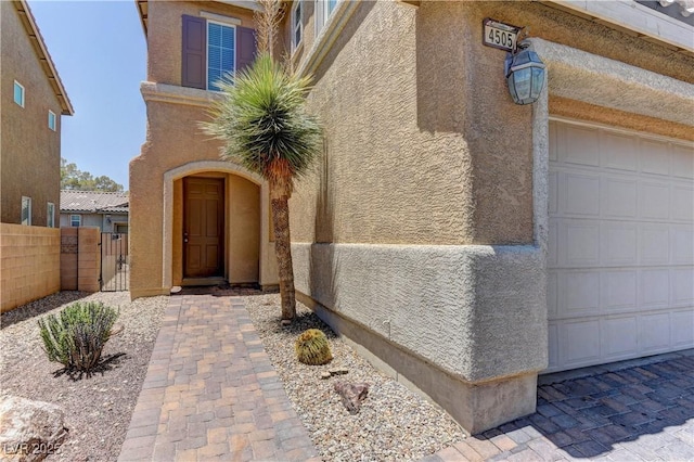 4505 Truscott Ct, Las Vegas, NV 89130 - view of exterior entry featuring stucco siding, a gate, and an attached garage