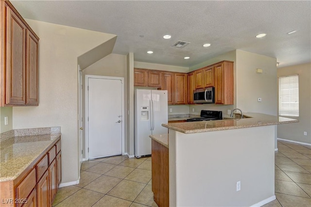 4505 Truscott Ct, Las Vegas, NV 89130 - kitchen with white fridge with ice dispenser, stainless steel microwave, gas stove, light tile patterned flooring, and recessed lighting