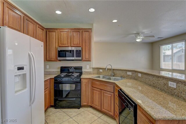 4505 Truscott Ct, Las Vegas, NV 89130 - kitchen with black appliances, brown cabinetry, light tile patterned flooring, recessed lighting, and light stone countertops