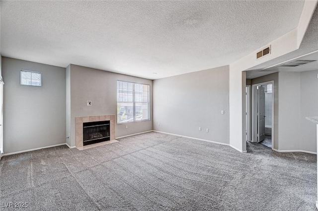 8555 W Russell Rd Unit 2015, Las Vegas, NV 89113 - unfurnished living room with carpet flooring, a textured ceiling, and a tiled fireplace