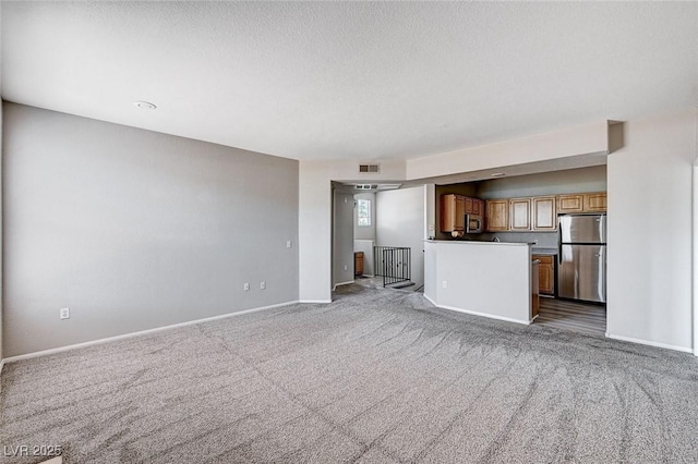 8555 W Russell Rd Unit 2015, Las Vegas, NV 89113 - unfurnished living room with carpet flooring and a textured ceiling