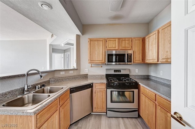8555 W Russell Rd Unit 2015, Las Vegas, NV 89113 - kitchen with appliances with stainless steel finishes and light wood-style flooring