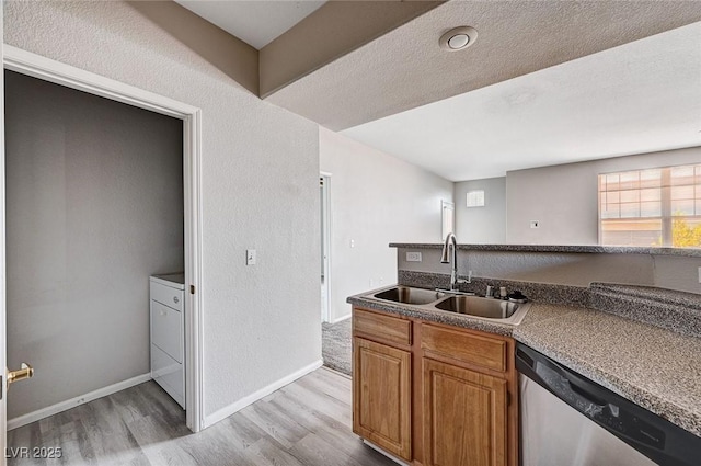 8555 W Russell Rd Unit 2015, Las Vegas, NV 89113 - kitchen featuring dishwasher, light wood-style flooring, and brown cabinetry