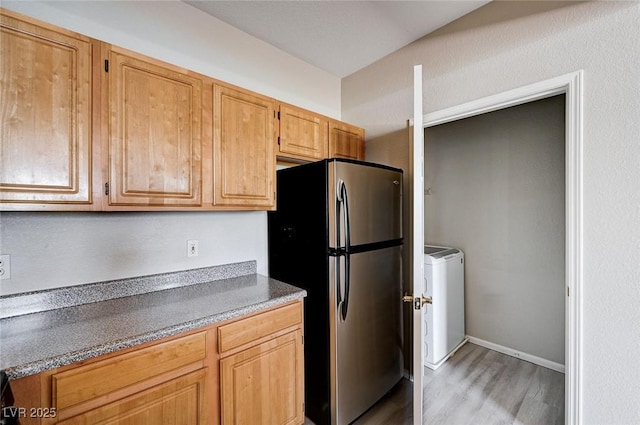 8555 W Russell Rd Unit 2015, Las Vegas, NV 89113 - kitchen featuring freestanding refrigerator, washer / clothes dryer, and light wood finished floors