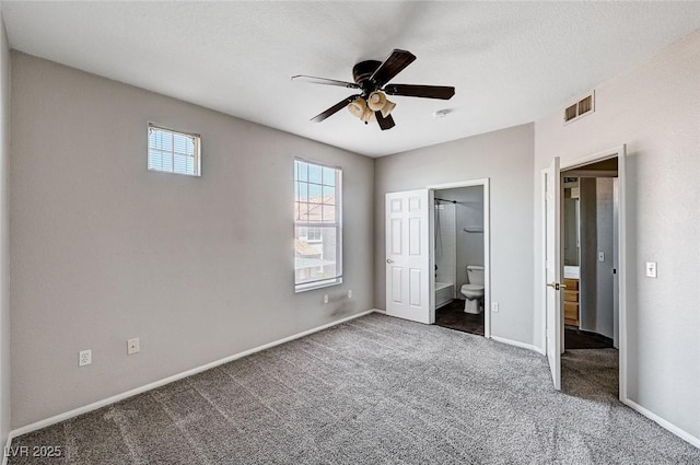 8555 W Russell Rd Unit 2015, Las Vegas, NV 89113 - unfurnished bedroom featuring carpet floors, connected bathroom, and a ceiling fan