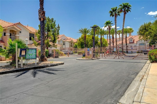 8555 W Russell Rd Unit 2015, Las Vegas, NV 89113 - view of asphalt street featuring curbs, a gate, a residential view, and a gated entry